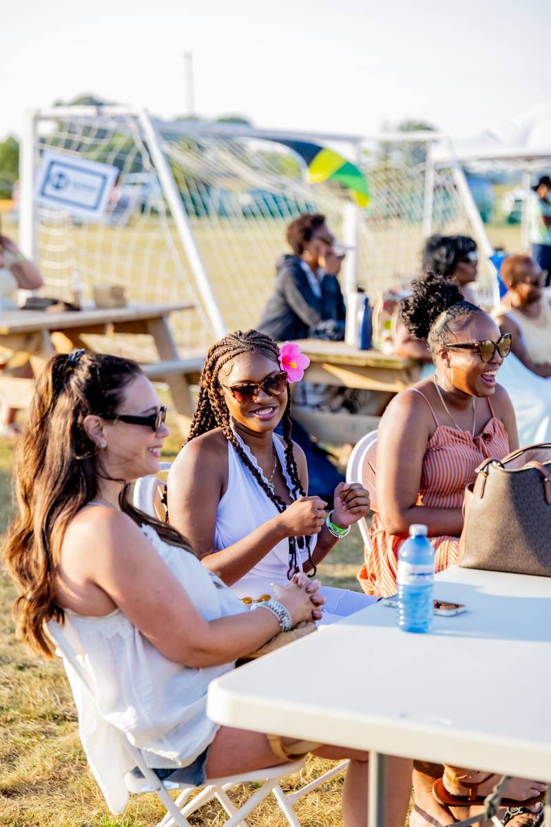 Friends laughing at a table at Grand Bend Jam Fest