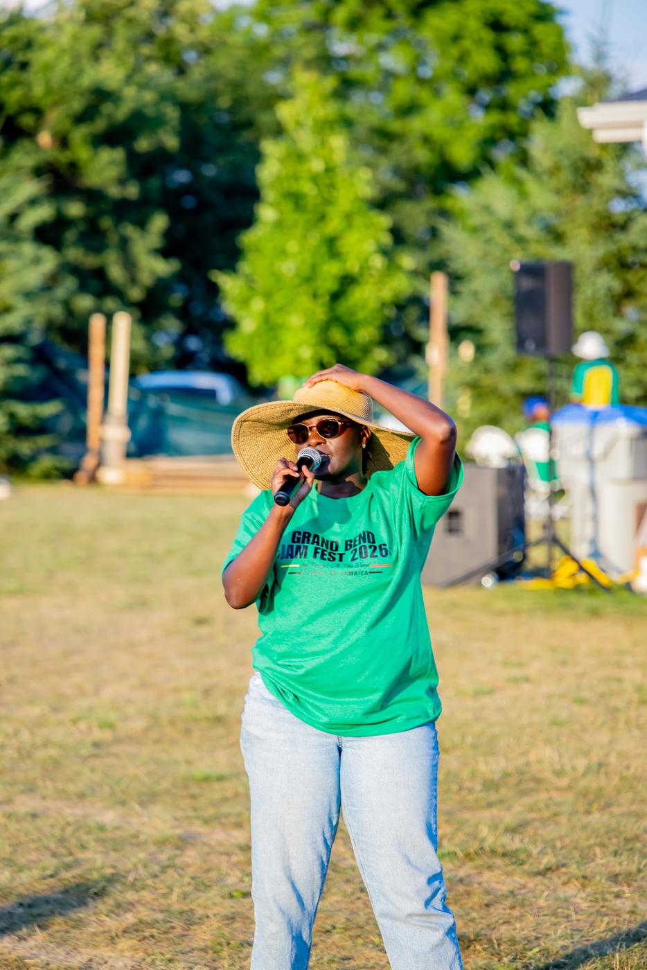 Talissa on the mic in a Grand Bend Jam Fest 2026 tee at Klondyke Sports Park
