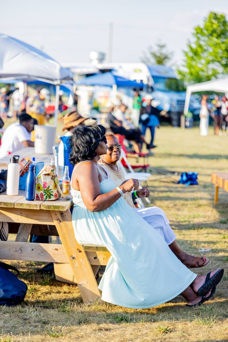 Guests at a picnic table at Jam Fest in golden light