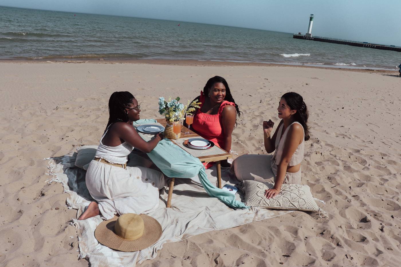 The Azure picnic kit — turquoise runner and yellow florals on the beach