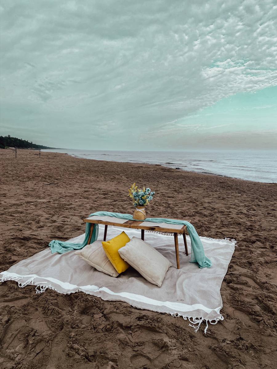 A styled picnic on the sand under an overcast Lake Huron sky